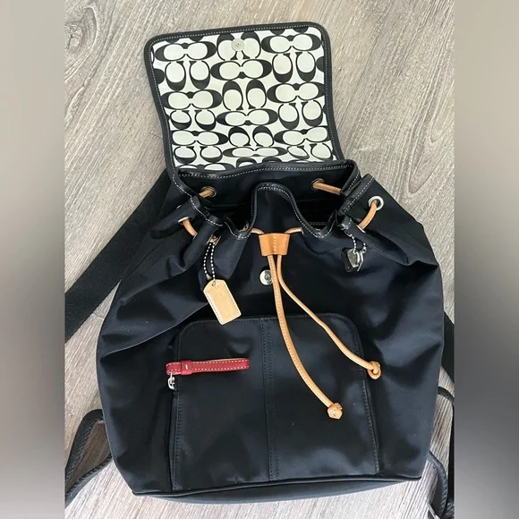 COACH canvas backpack and COACH leather wallet.